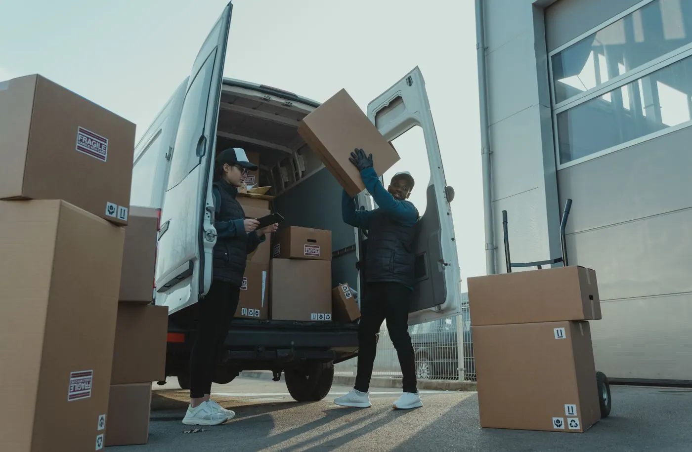Distribution team loading packaged supplies into a delivery van